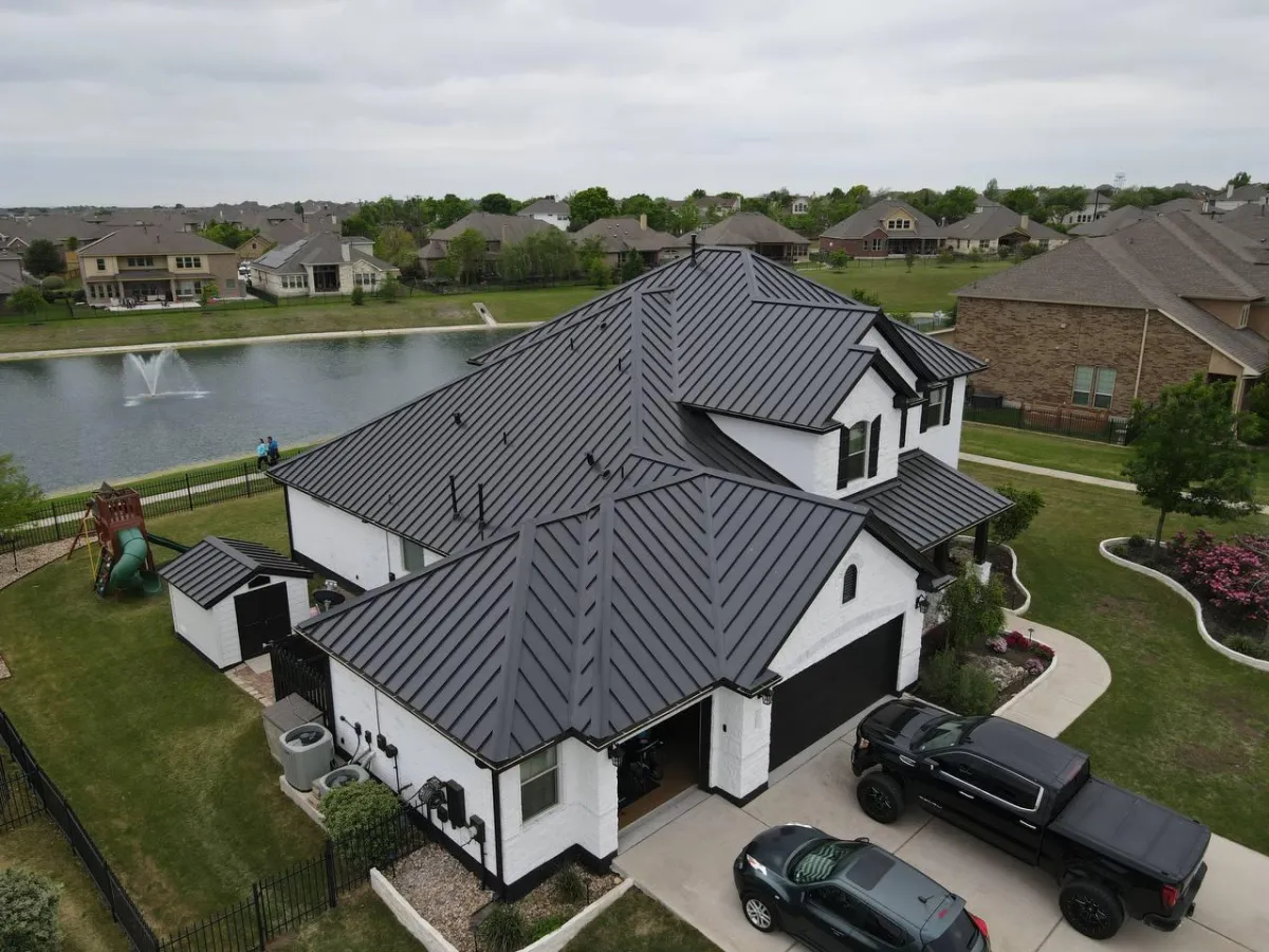 Completed luxury home with dark standing seam metal roof